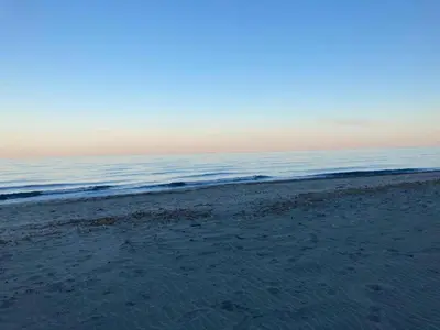 a sandy beach with the ocean in the background at Apartment in Moriani-Plage by the Beach in San-Nicolao