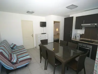 a kitchen and dining room with a table and chairs at Apartment in Moriani-Plage by the Beach in San-Nicolao