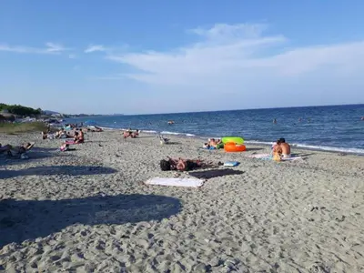 a group of people laying on a beach at Holiday Home in Moriani-Plage near Beach in San-Nicolao
