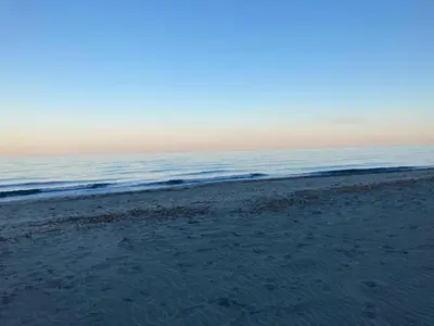 a sandy beach with the ocean in the background at Holiday Home in Moriani-Plage near Beach in San-Nicolao