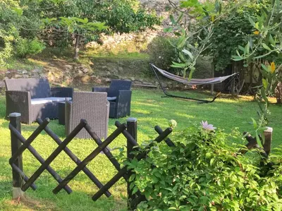 a fence with chairs and a hammock in a yard at Sole e Ventu (70 qm) in San-Giovanni-di-Moriani