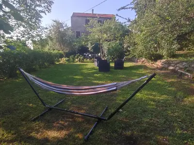 a hammock on the grass in a yard at Sole e Ventu (70 qm) in San-Giovanni-di-Moriani