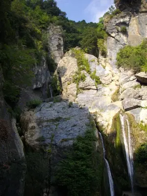 a waterfall on the side of a rocky mountain at Sole e Ventu 30qm in San-Giovanni-di-Moriani