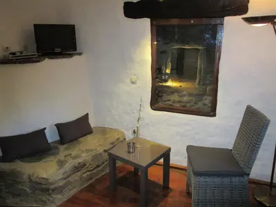 a living room with a couch and a table at Sole e Ventu 30qm in San-Giovanni-di-Moriani
