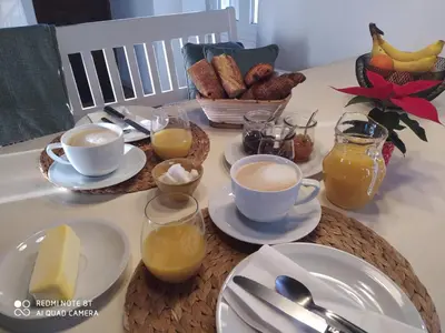 a table topped with cups of coffee and breakfast foods at Sole e Ventu 30qm in San-Giovanni-di-Moriani