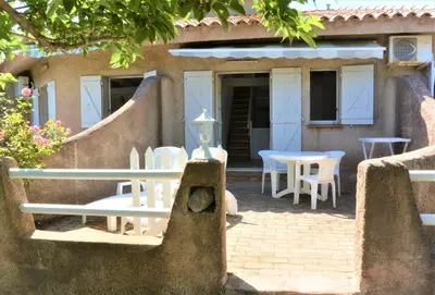 a house with a patio with chairs and tables at CANELLA 2 in Favone