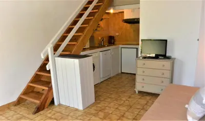 a kitchen with a staircase and a television in a room at CANELLA 2 in Favone