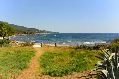 a dirt path leading to a beach with the ocean at CANELLA 4 in Favone