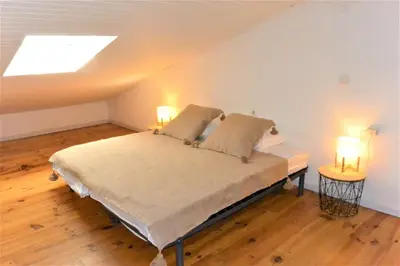 a bedroom with a bed with two lamps on it at CANELLA 5 in Favone