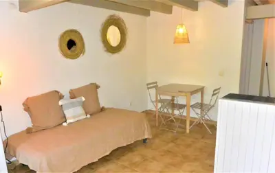 a bedroom with a bed and a table with chairs at CANELLA 5 in Favone