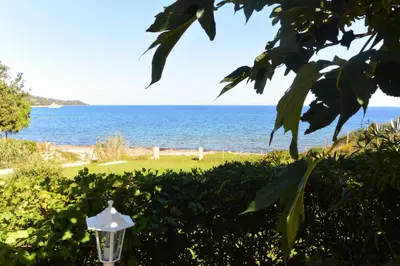 a view of the ocean from a garden with a street light at CANELLA 5 in Favone