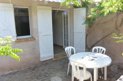 a white table and chairs on a patio at CANELLA 5 in Favone