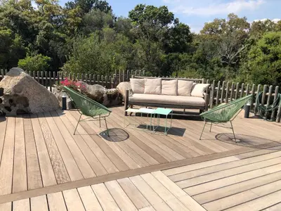 a couch and two chairs on a wooden deck at villa rocca in Sotta