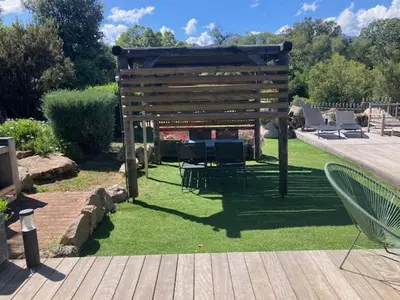 a wooden pergola sitting on top of a lawn at villa rocca in Sotta