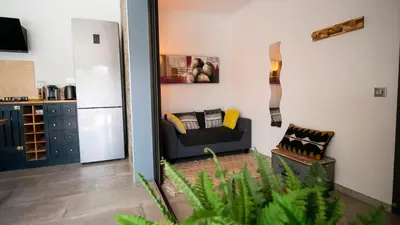 a living room with a couch and a refrigerator at villa rocca in Sotta