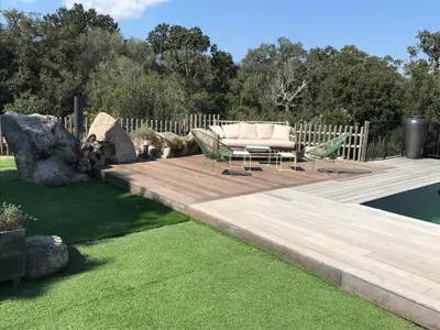 a wooden deck with a couch and chairs on it at villa rocca in Sotta