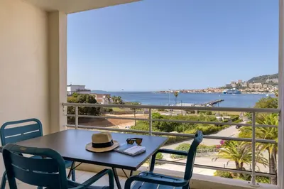 a table with a hat on a balcony with a view at Best Western Plus Ajaccio Amirauté in Ajaccio