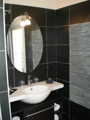 a bathroom with a sink and a mirror at Augustin Marie in Bonifacio