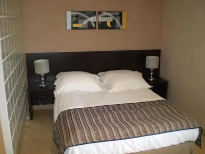 a bedroom with a large bed with two night stands at Augustin Marie in Bonifacio