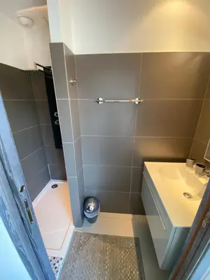 a bathroom with a shower and a sink and a toilet at Le Haut de la Vague in Porto-Vecchio