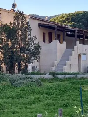 a building with stairs in front of a building at U Palmu in Sagone