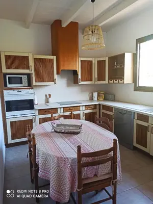 a kitchen with a table with a table cloth on it at U Palmu in Sagone