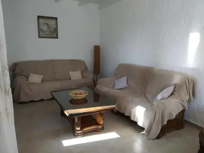 a living room with a couch and a coffee table at U Palmu in Sagone