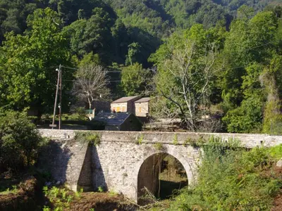 a stone bridge with a house on top of it at Sole e Ventu 50qm in San-Giovanni-di-Moriani