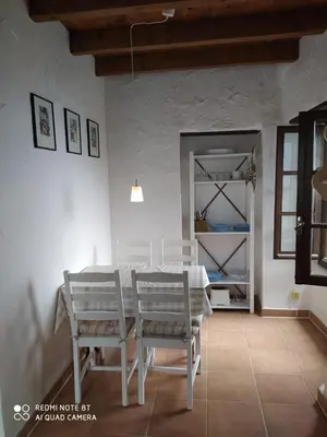 a dining room with a white table and chairs at Sole e Ventu 50qm in San-Giovanni-di-Moriani