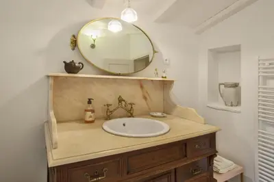 a bathroom with a sink and a mirror at Casa La Colombaia in Poggio-di-Nazza