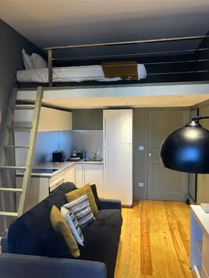 a living room with a couch and a bunk bed at Les Terrasses de Padoue in Corte