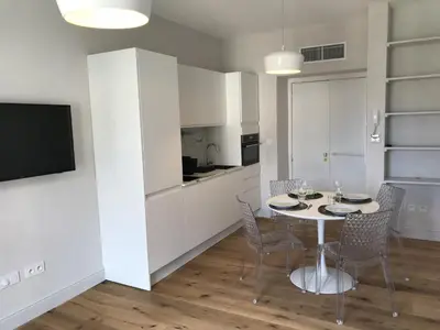 a kitchen and dining room with a table and chairs at Les Terrasses de Padoue in Corte