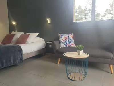 a bedroom with a bed and a couch and a table at Casa Dea in Corte