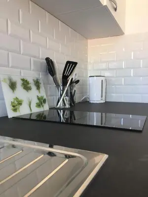 a kitchen counter with a glass table with utensils at Casa Dea in Corte