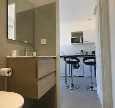 a kitchen with a sink and two bar stools at Casa Dea in Corte