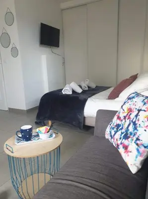 a room with two beds and a couch and a table at Casa Dea in Corte