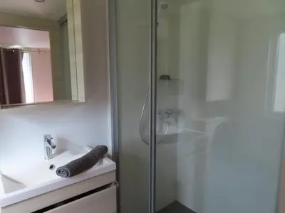 a bathroom with a shower and a sink at Residence U Veniqui in Favone