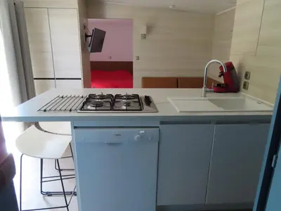 a kitchen with a stove and a sink at Residence U Veniqui in Favone