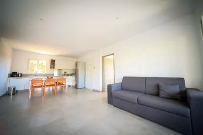 a living room with a couch and a table at SARL Valinco locations appartement 2 chambres in Olmeto