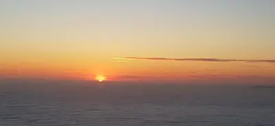 a sunset over the ocean with the sun in the sky at Villa Acqua Doria in Coti-Chiavari