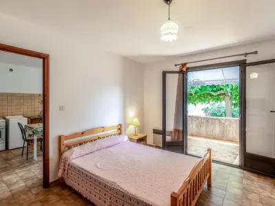 a bedroom with a bed and a sliding glass door at Apartment Dami II-1 by Interhome in Moriani Plage