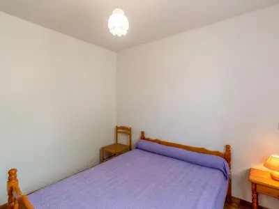 a bedroom with a bed with a purple comforter at Apartment Dami II-1 by Interhome in Moriani Plage