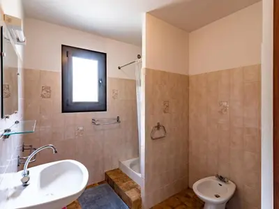 a bathroom with a sink and a tub and a toilet at Apartment Dami II-1 by Interhome in Moriani Plage
