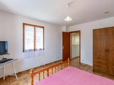 a bedroom with a bed and a desk and a tv at Apartment Dami II-2 by Interhome in Moriani Plage