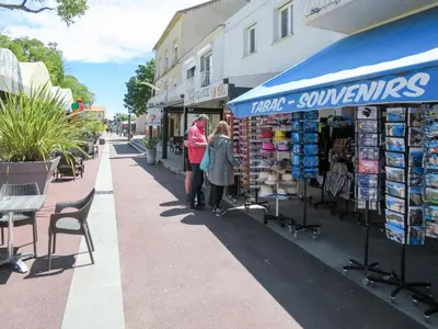 a couple of people standing in front of a store at Apartment Dami II-2 by Interhome in Moriani Plage