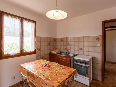 a small kitchen with a table and a stove at Apartment Dami II-2 by Interhome in Moriani Plage