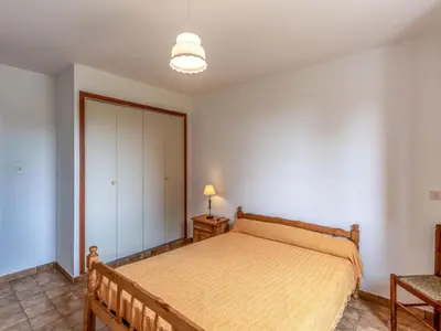 a bedroom with a bed in a room at Apartment Dami II-2 by Interhome in Moriani Plage