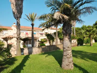 a group of palm trees in front of a house at Holiday Home Les Chênes by Interhome in Borgo
