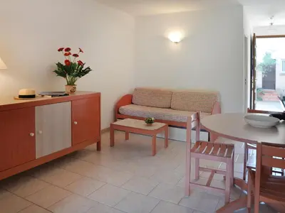 a living room with a couch and a table at Holiday Home Les Chênes by Interhome in Borgo