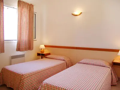 two twin beds in a room with a window at Holiday Home Les Chênes by Interhome in Borgo